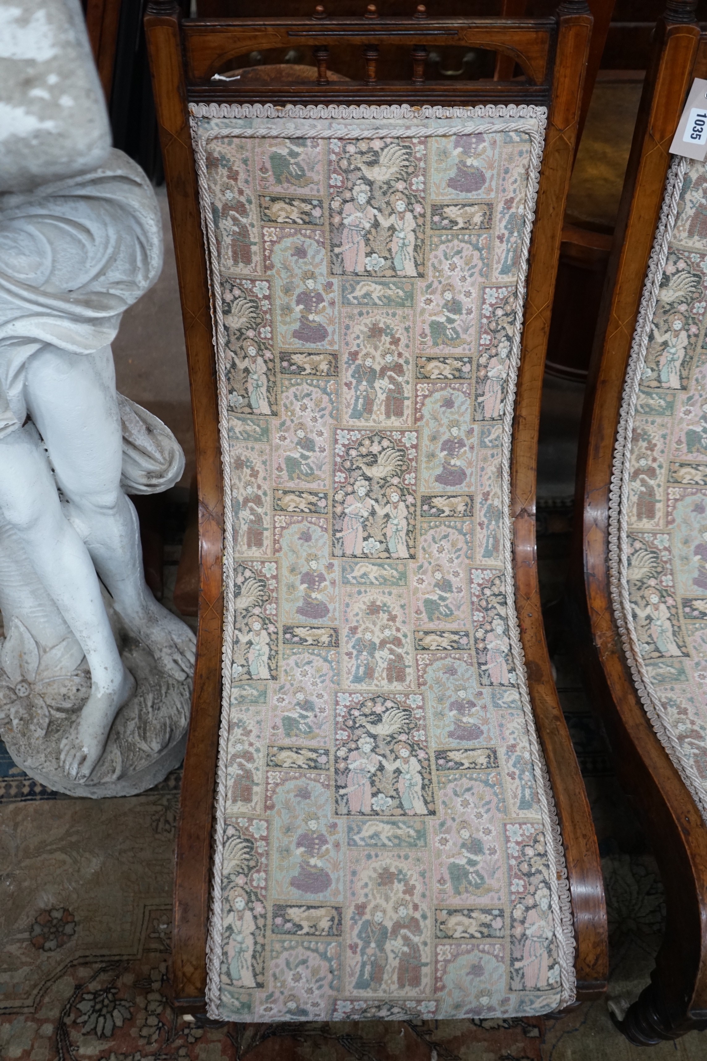 A pair of Victorian inlaid mahogany slipper chairs